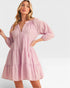 Woman wearing a pink dress on a white background