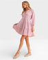 Woman wearing a pink dress on a white background