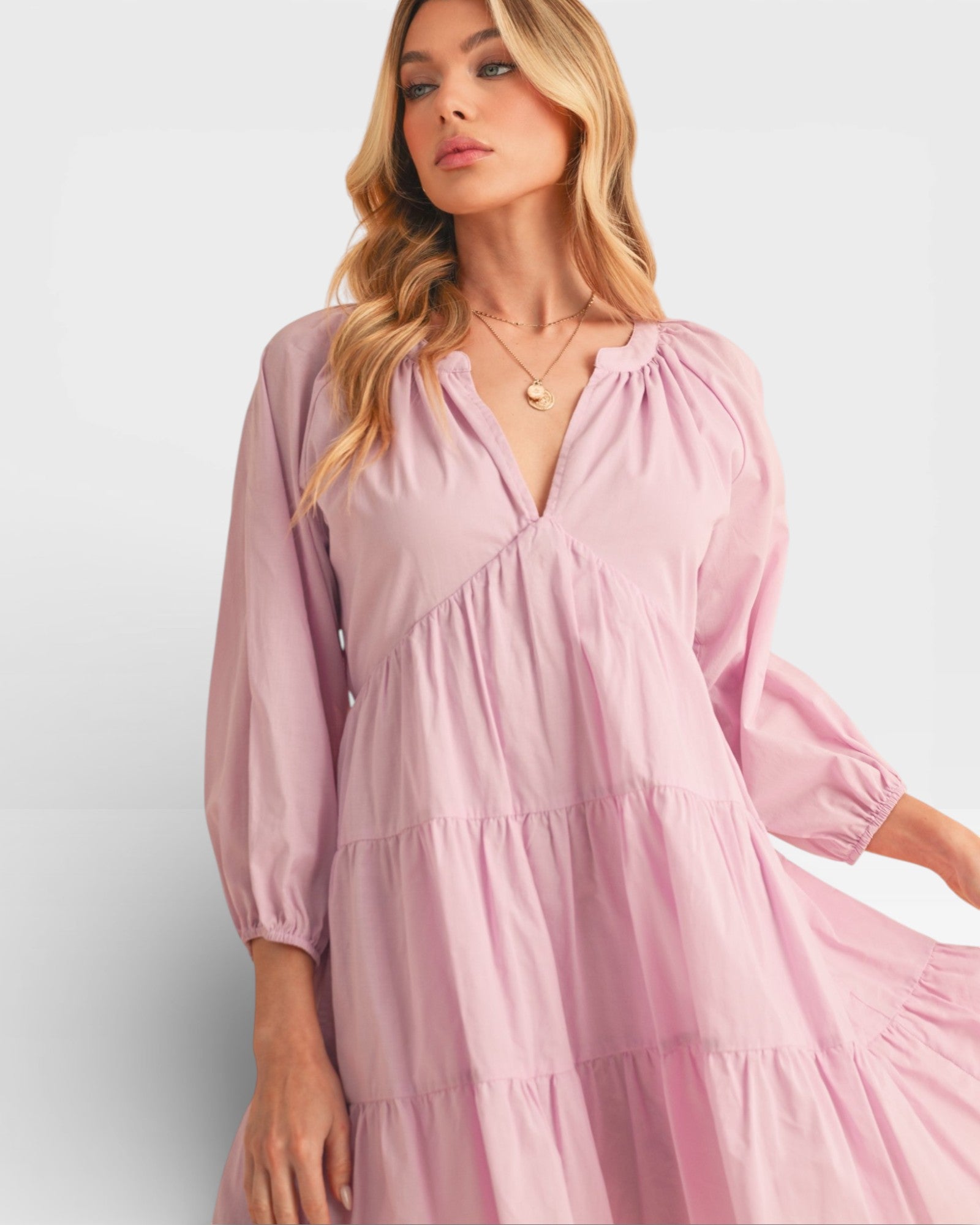 Woman wearing a pink dress against a white background