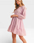 Woman wearing a pink dress on a white background