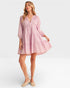 Woman wearing a pink dress on a white background