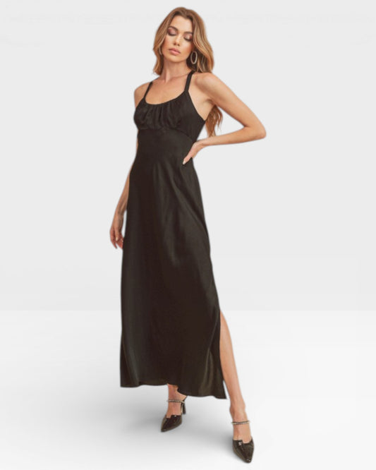 Woman wearing a black sleeveless dress with a slit on a white background