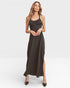 Woman wearing a black dress with a slit on a white background