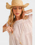 Woman wearing a straw hat and light pink dress with a long necklace.