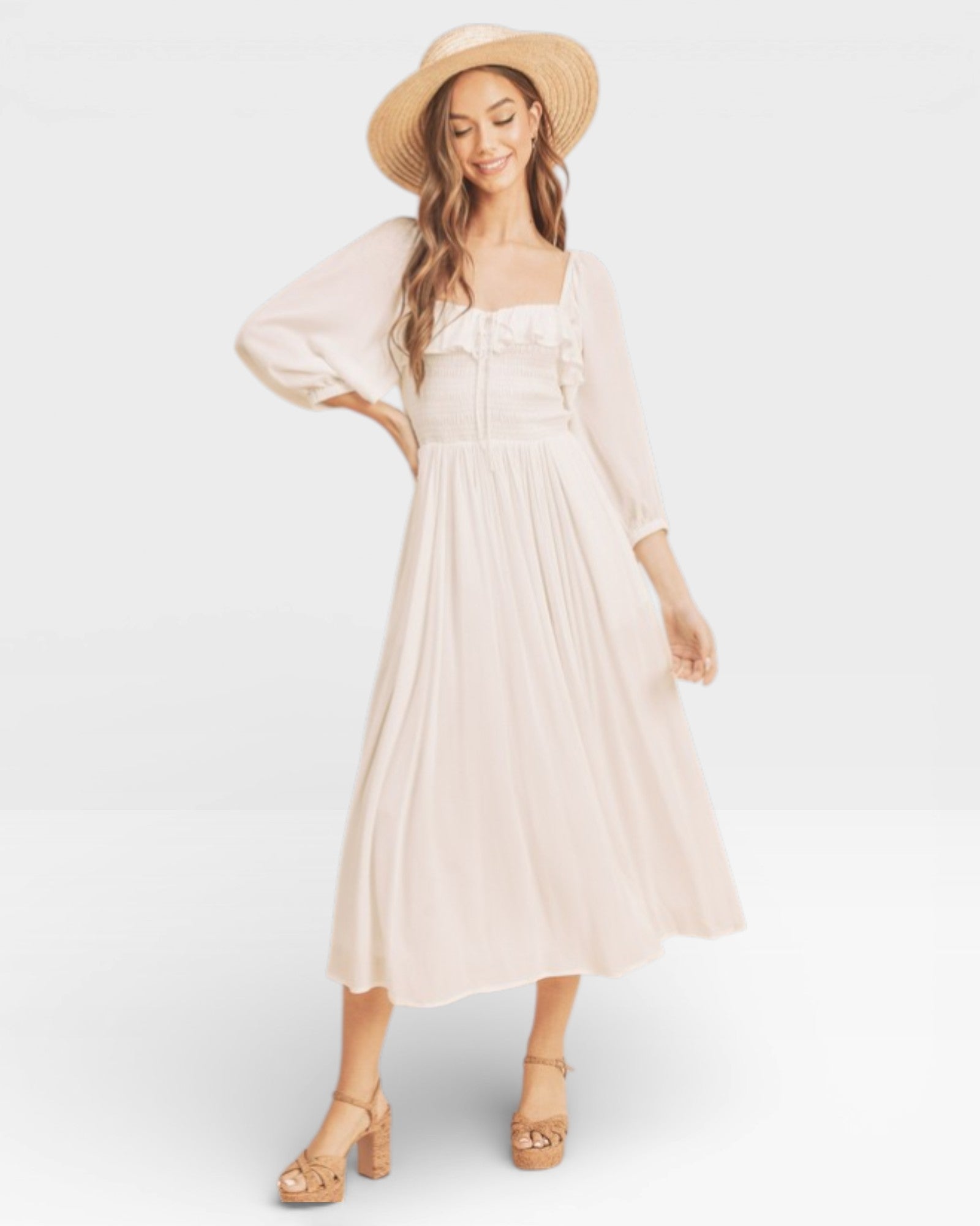 Woman wearing a light pink dress and straw hat on a white background