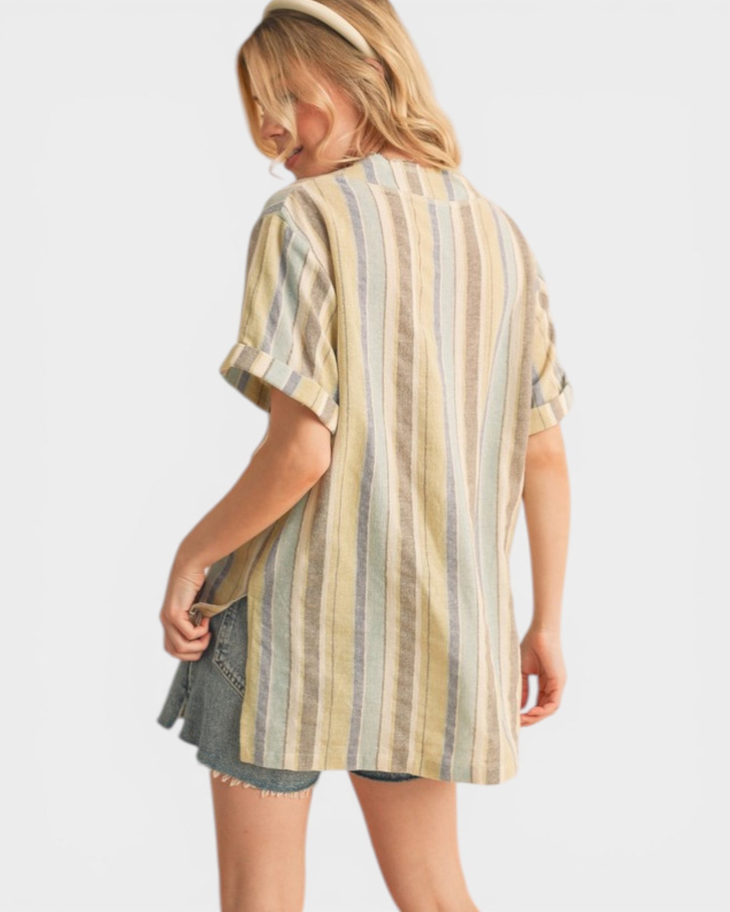 Woman wearing a striped shirt and denim shorts on a white background