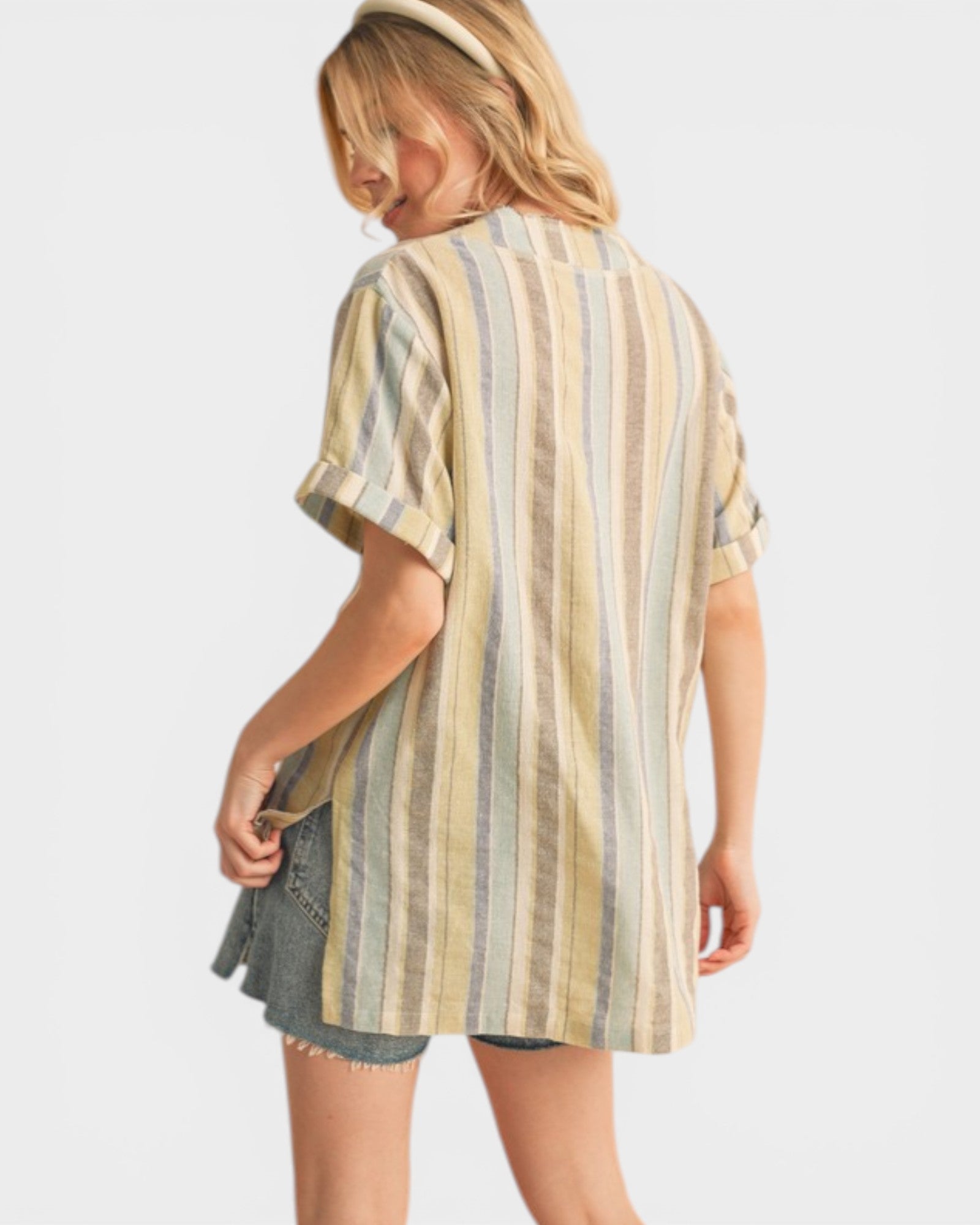 Woman wearing a striped shirt and denim shorts on a white background