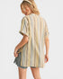 Woman wearing a striped shirt and denim shorts on a white background