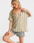 Woman wearing a striped shirt and shorts on a plain background