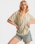 Woman wearing a striped shirt and denim shorts on a white background