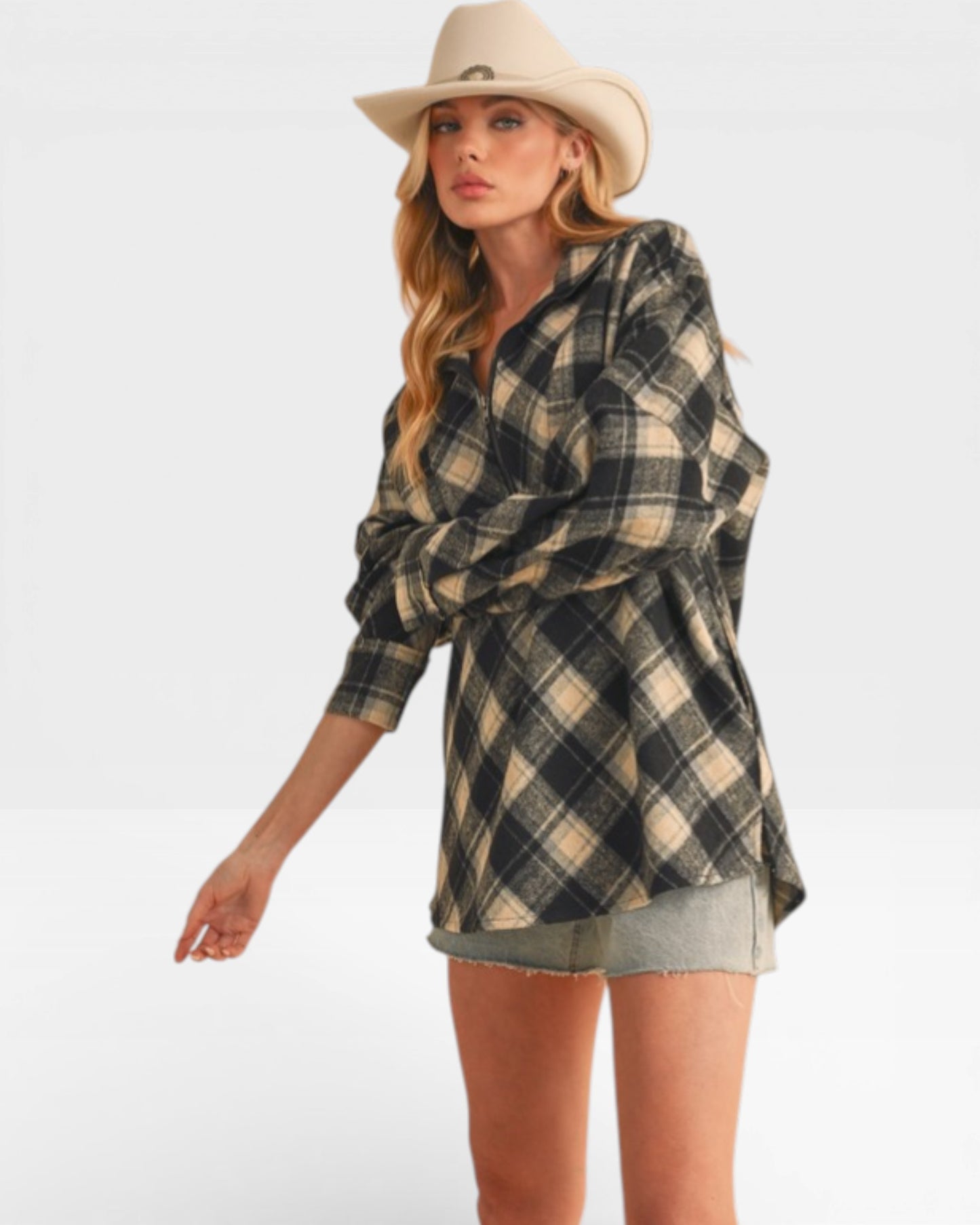 Woman wearing a plaid shirt and cowboy hat on a white background