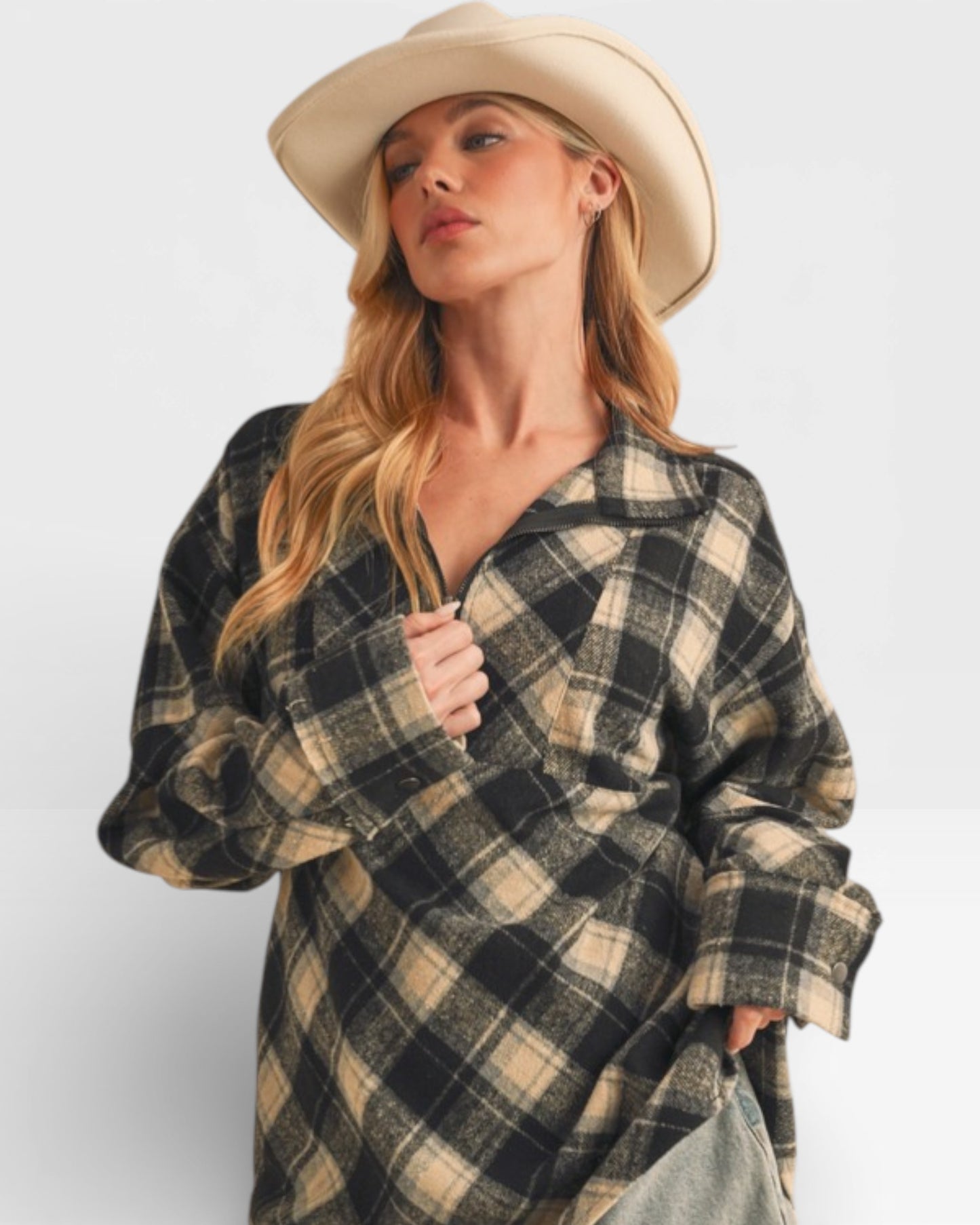 Woman wearing a plaid shirt and cowboy hat on a white background