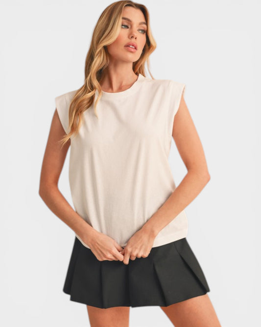 Woman wearing a white sleeveless top and black skirt on a white background