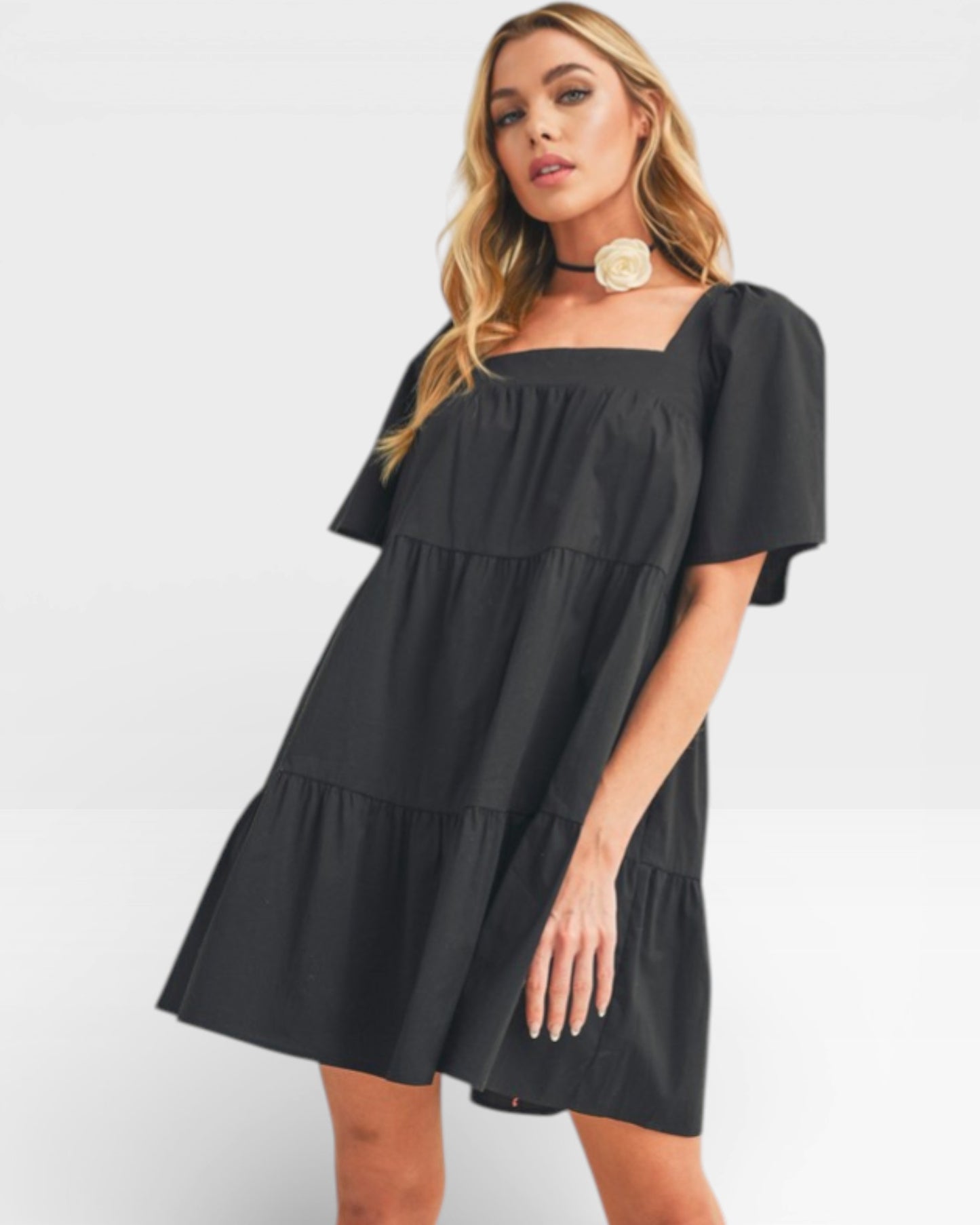 Woman wearing a black dress on a white background