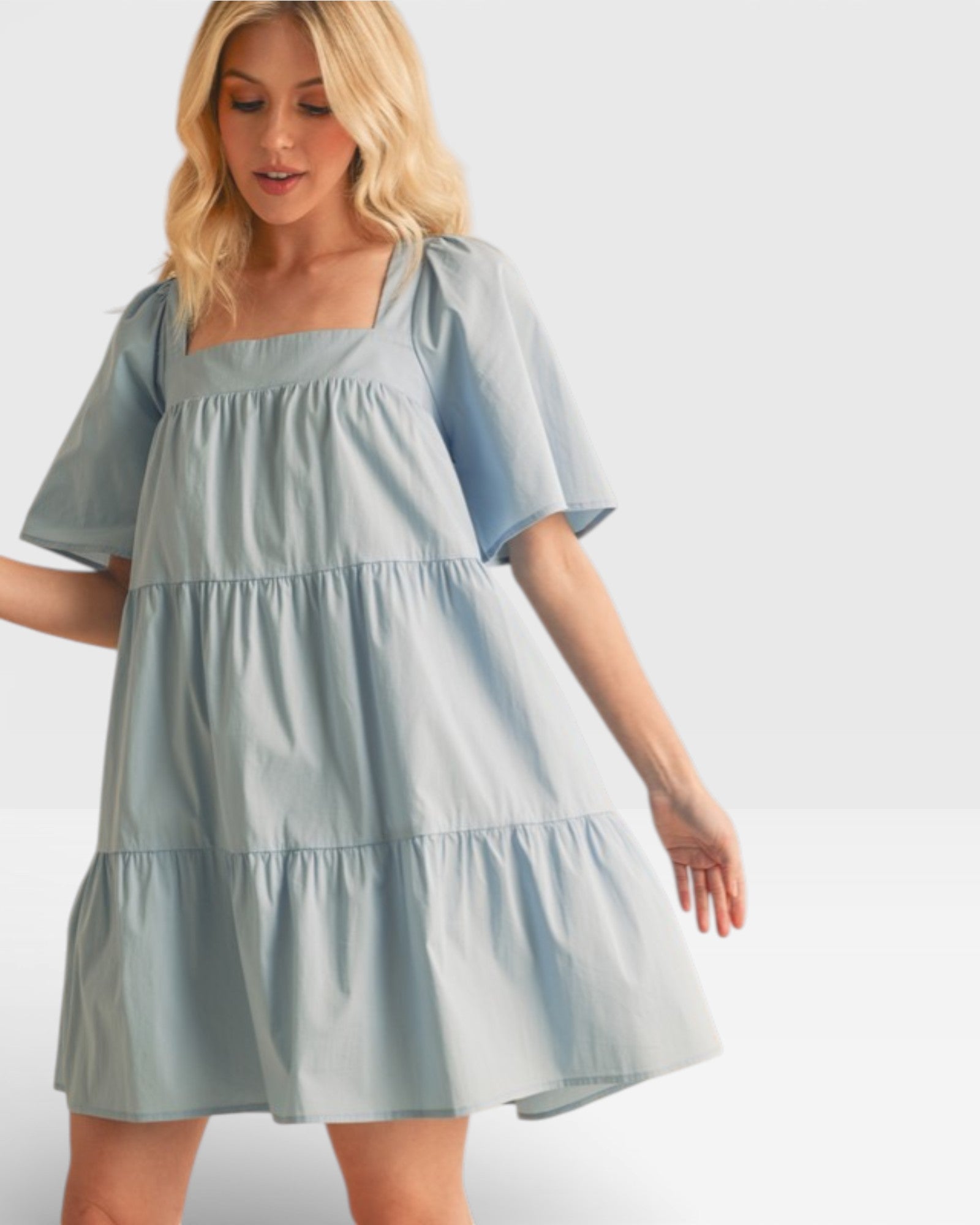 Woman wearing a light blue dress on a white background
