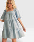 Woman wearing a light blue dress on a white background