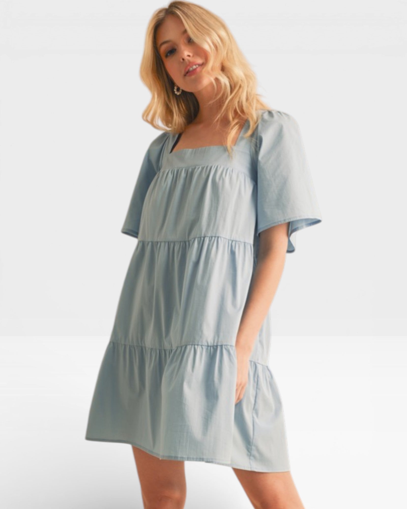 Woman wearing a light blue dress on a white background