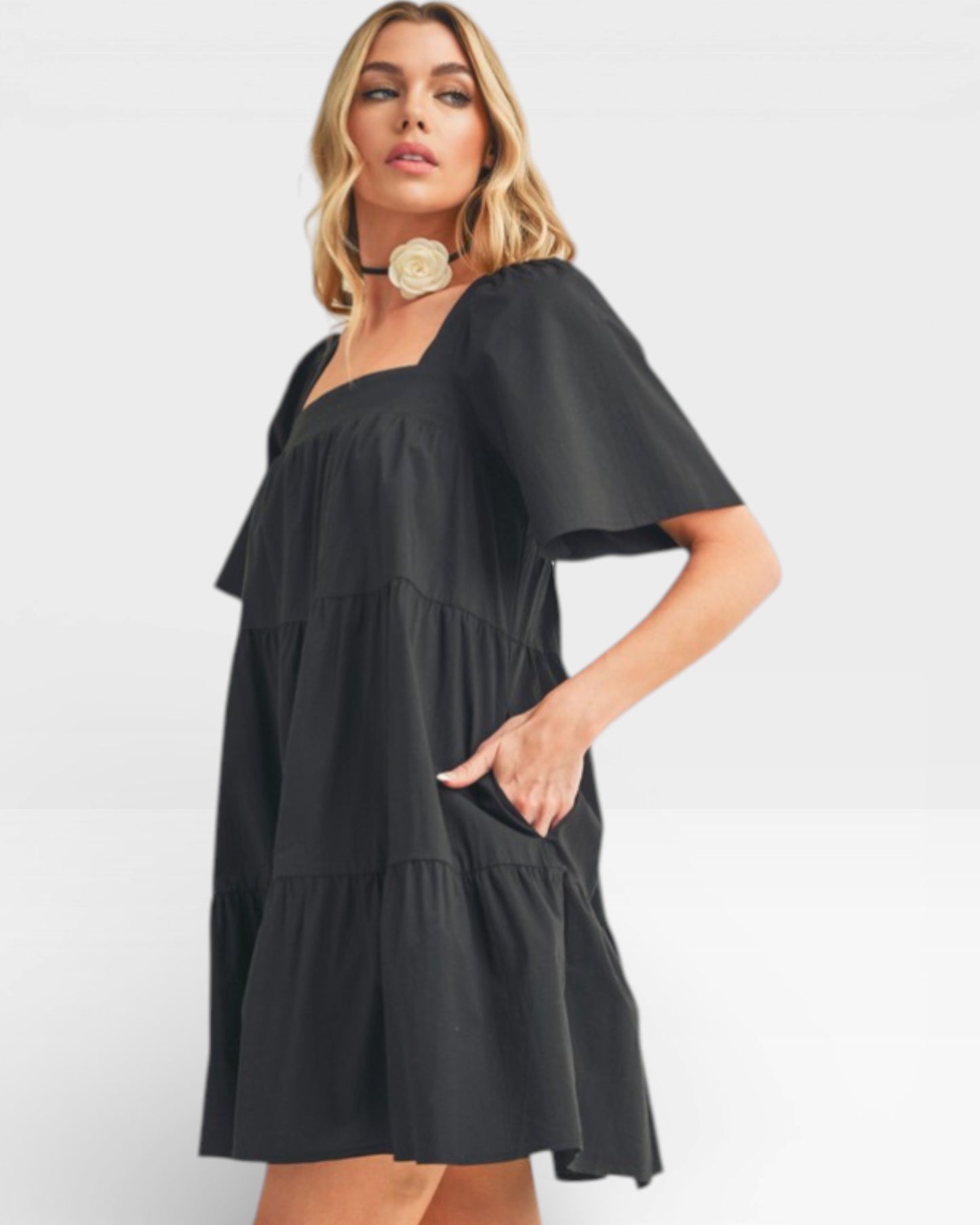 Woman wearing a black dress with a white background