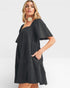 Woman wearing a black dress with a white background