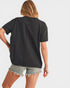 Person wearing a black t-shirt and denim shorts on a white background