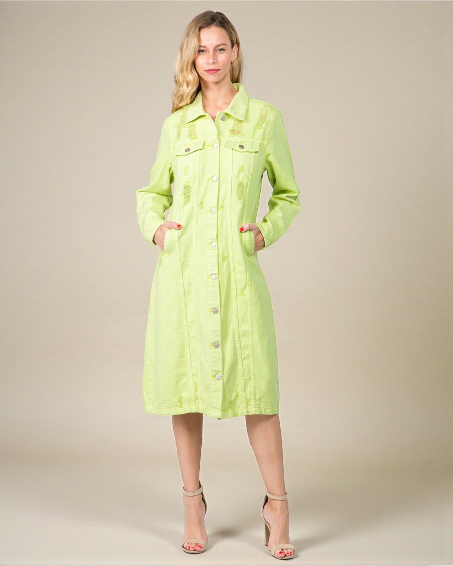 Woman wearing a light green dress against a plain background