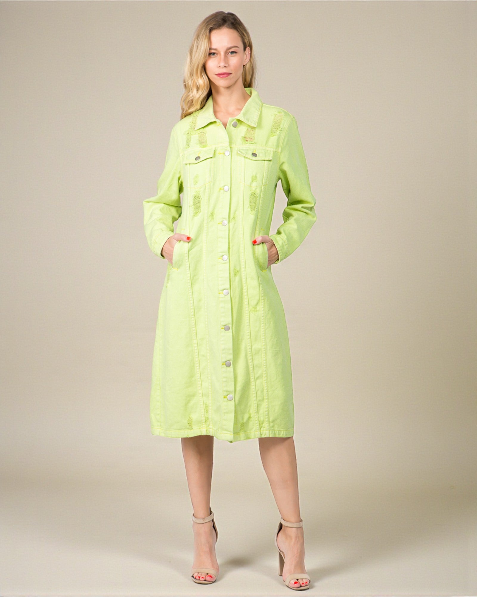 Woman wearing a light green dress against a plain background