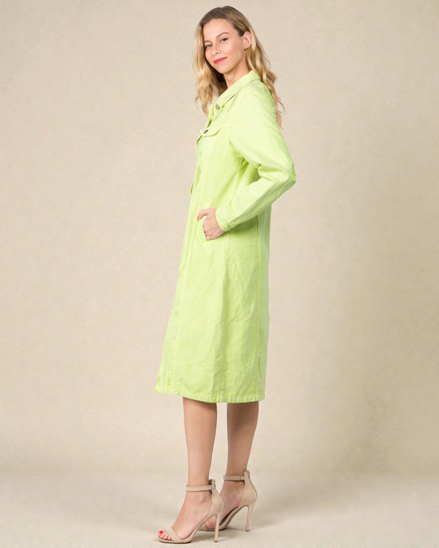 Woman wearing a light green dress against a beige background