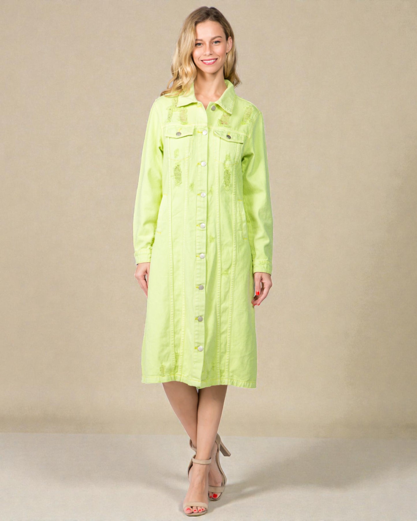 Woman wearing a light green dress against a beige background