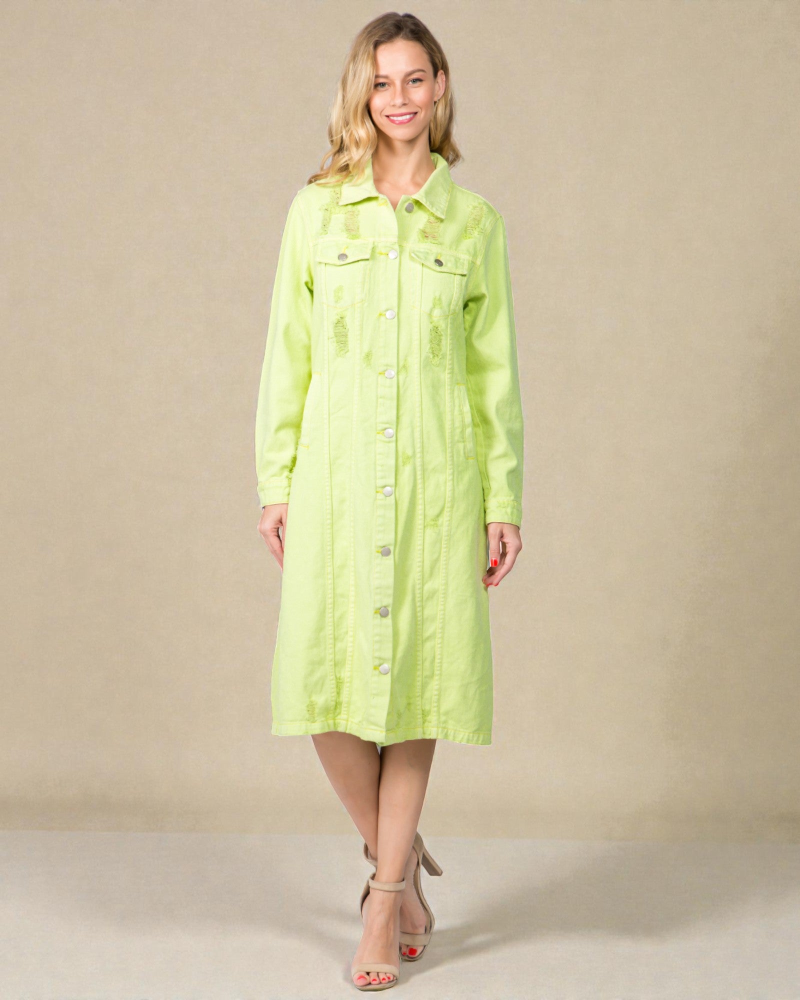 Woman wearing a light green dress against a beige background