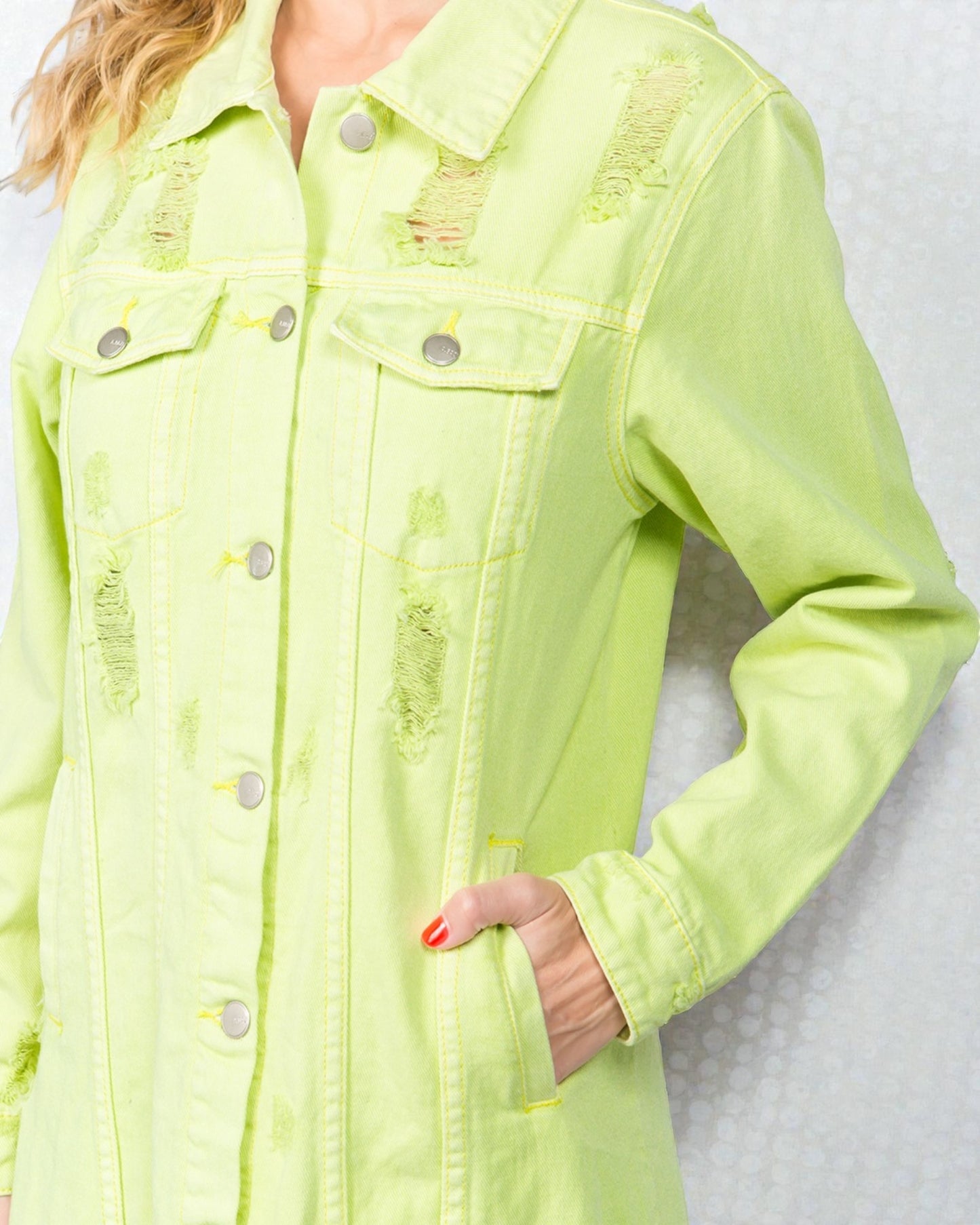 Light green denim jacket with distressed details on a white background