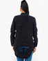 A woman viewed from the back wearing a black distressed denim jacket with ripped details and blue jeans, against a plain white background.
