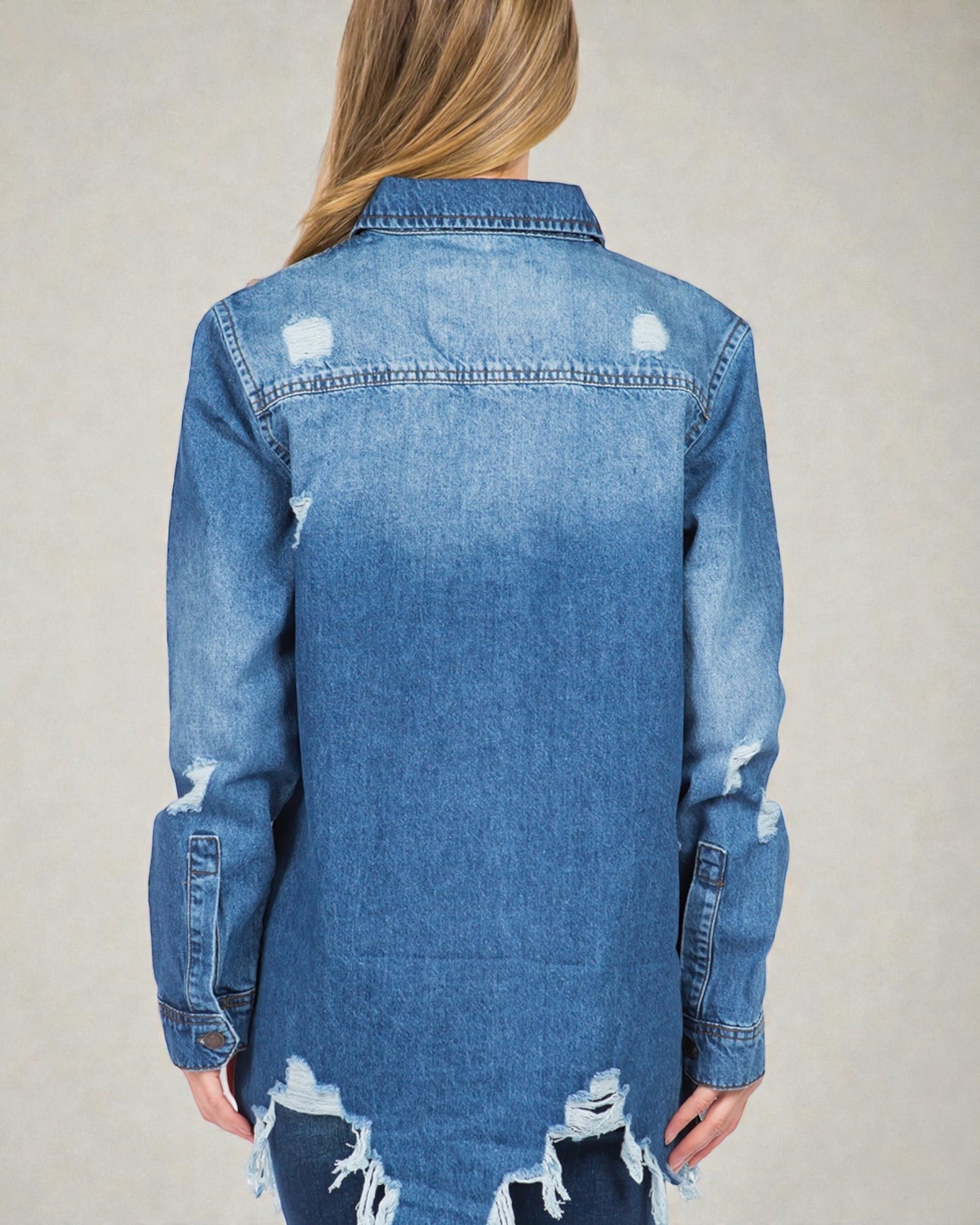 Blue denim jacket with distressed details on a plain background