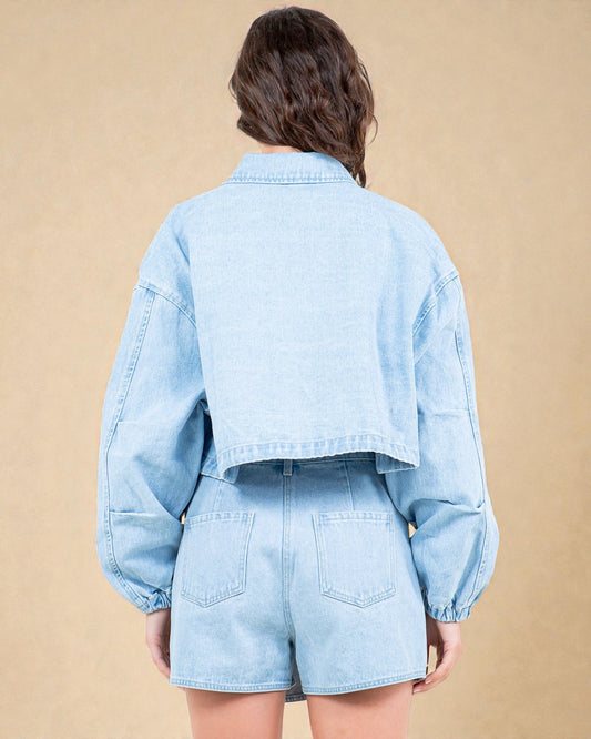 Light blue denim jacket and shorts worn by a person on a beige background