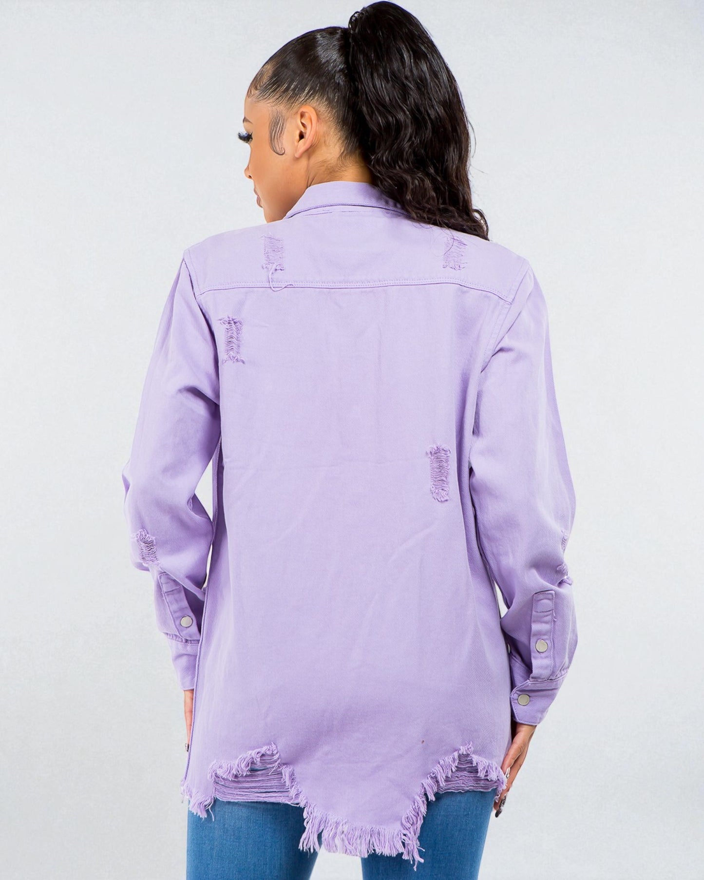 Person wearing a light purple denim jacket on a white background