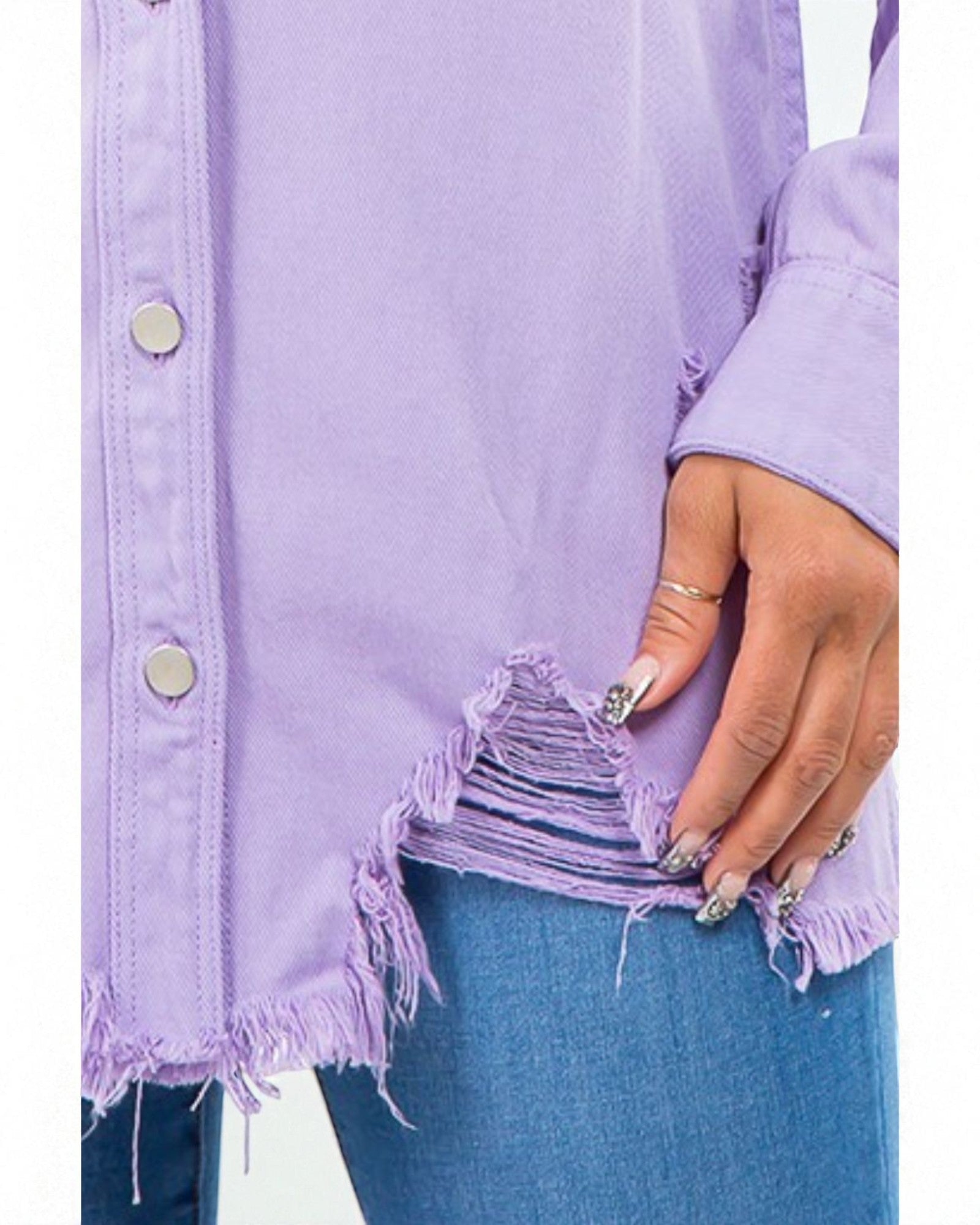 Person wearing a light purple denim jacket with frayed hem, holding the sleeve.