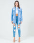 Woman wearing a light blue denim jacket and jeans on a white background