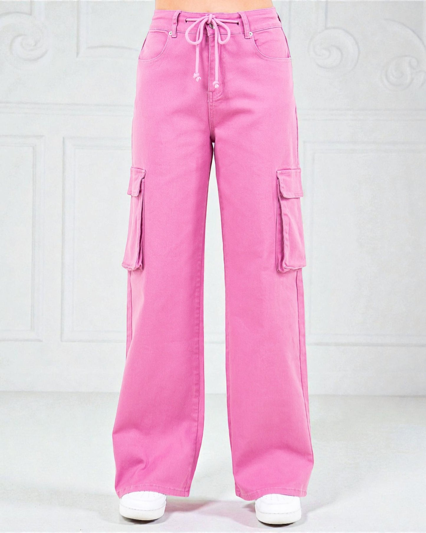 Pink cargo pants on a white background