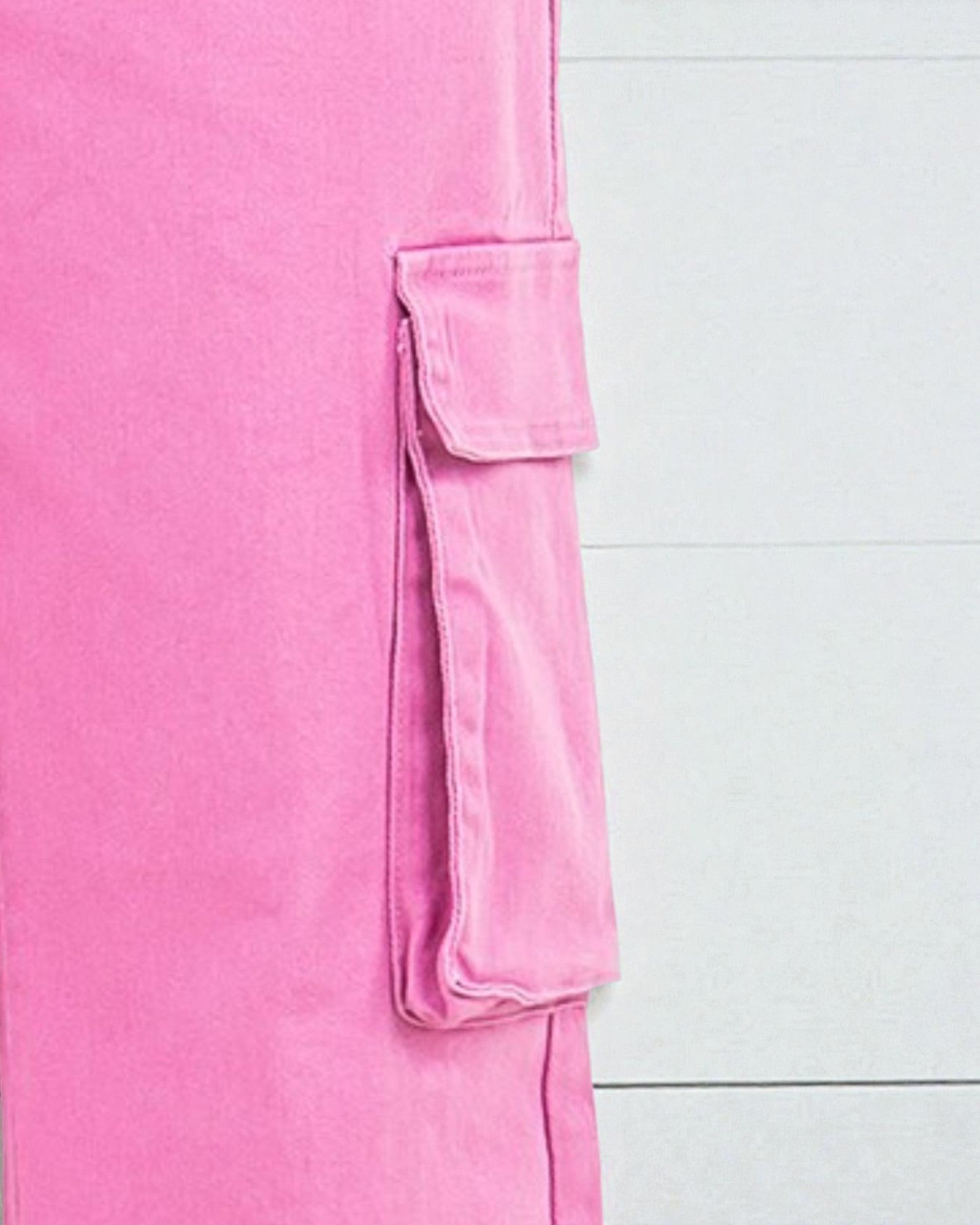 Close-up of a pink garment with a pocket on a white background