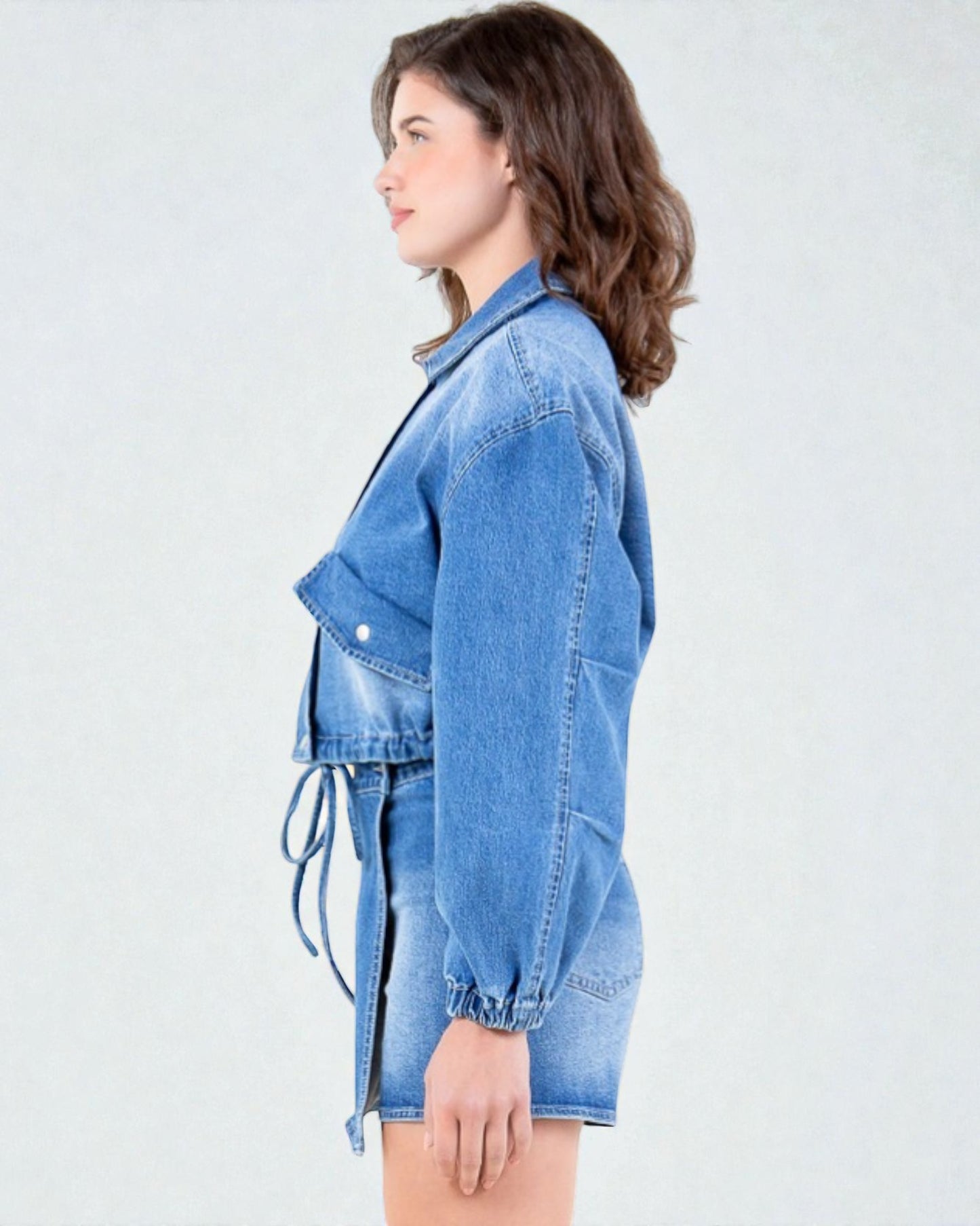 Woman wearing a blue denim jacket on a white background