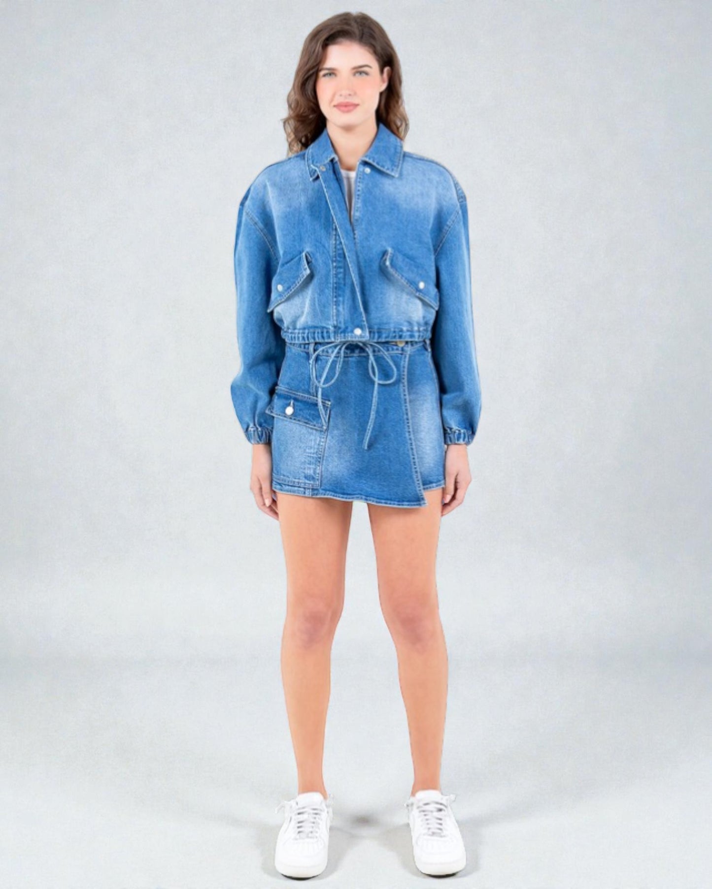 Woman wearing a blue denim outfit on a white background