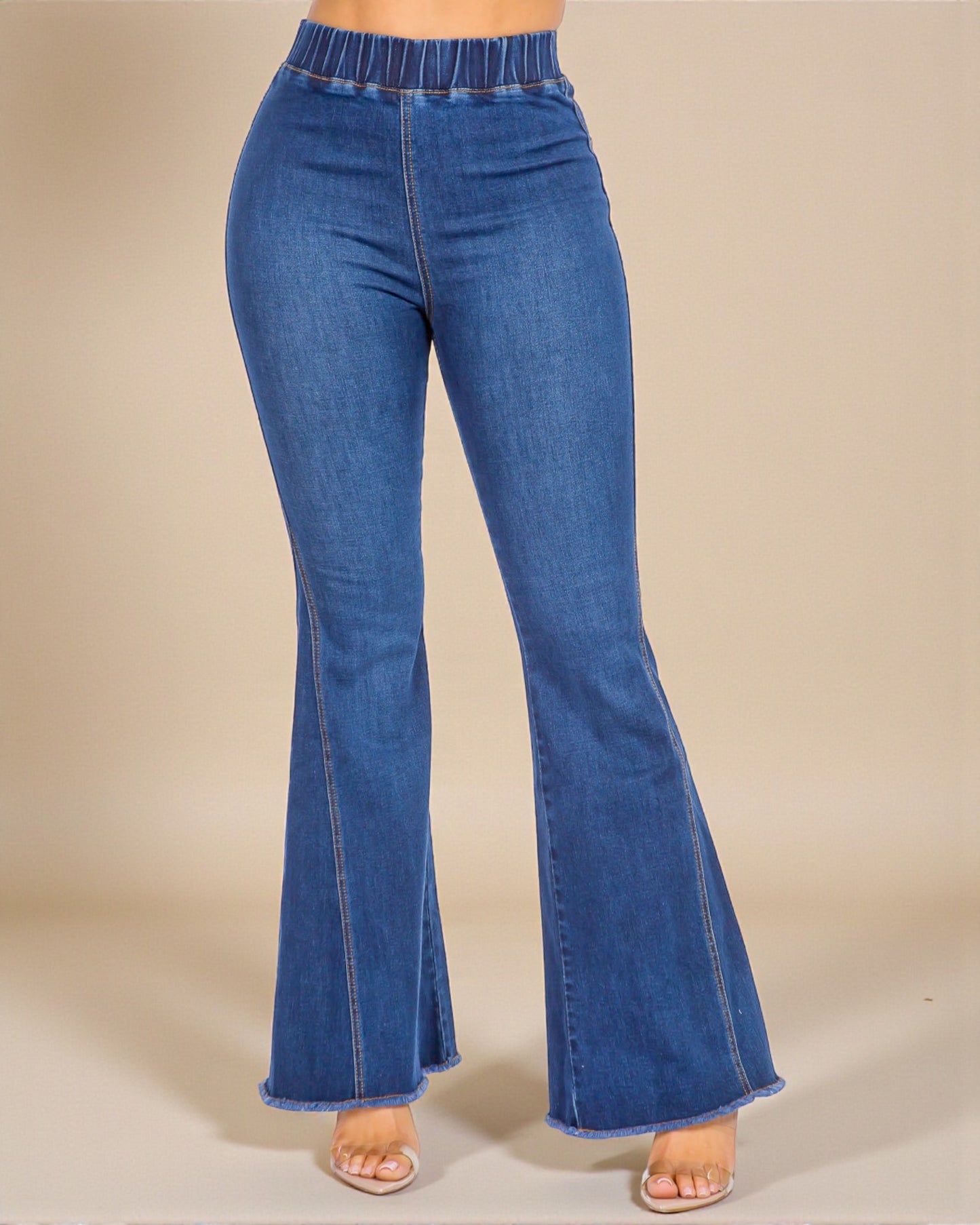 Blue flared jeans on a beige background