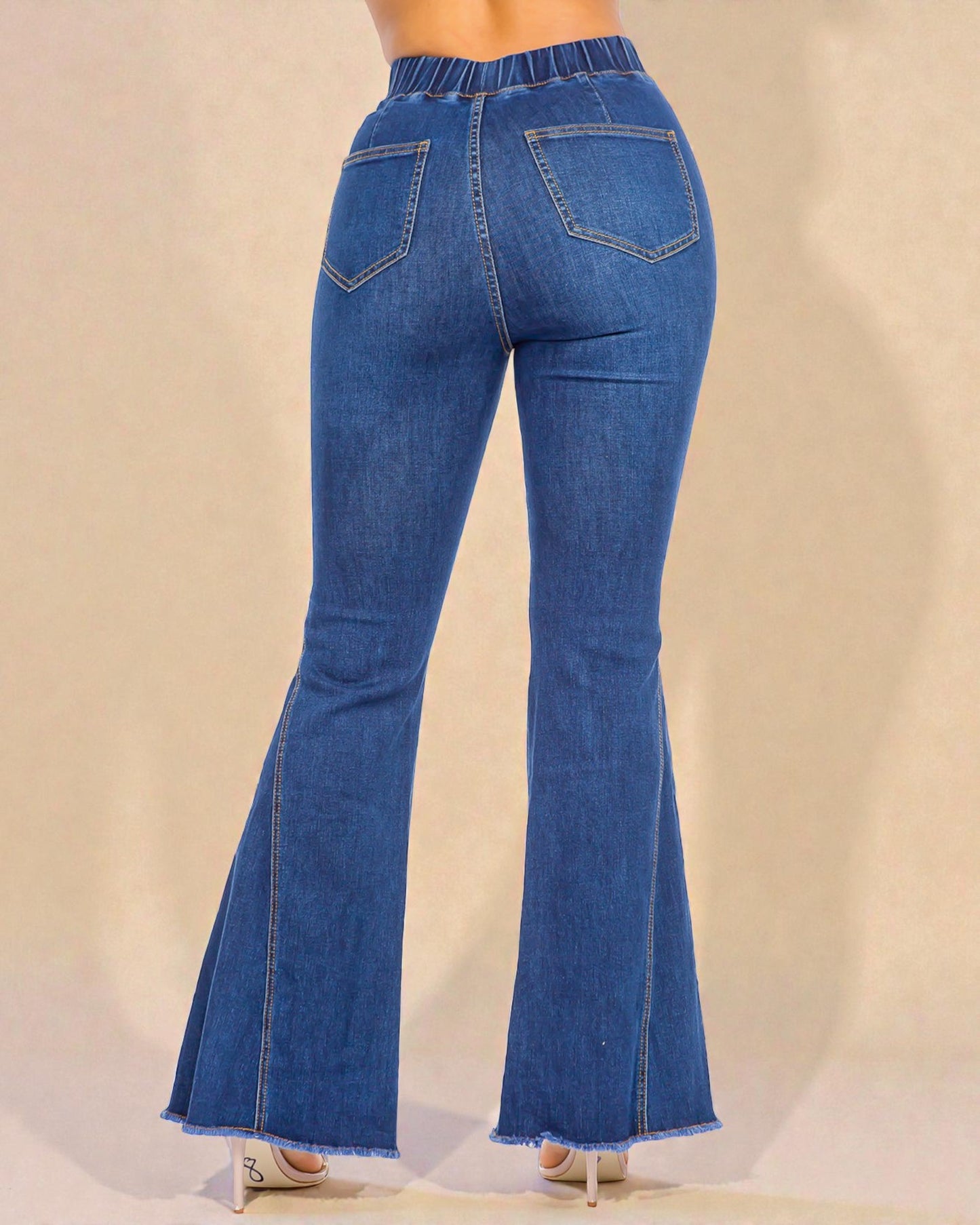 Blue flared jeans on a beige background