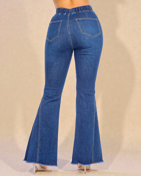 Blue flared jeans on a beige background