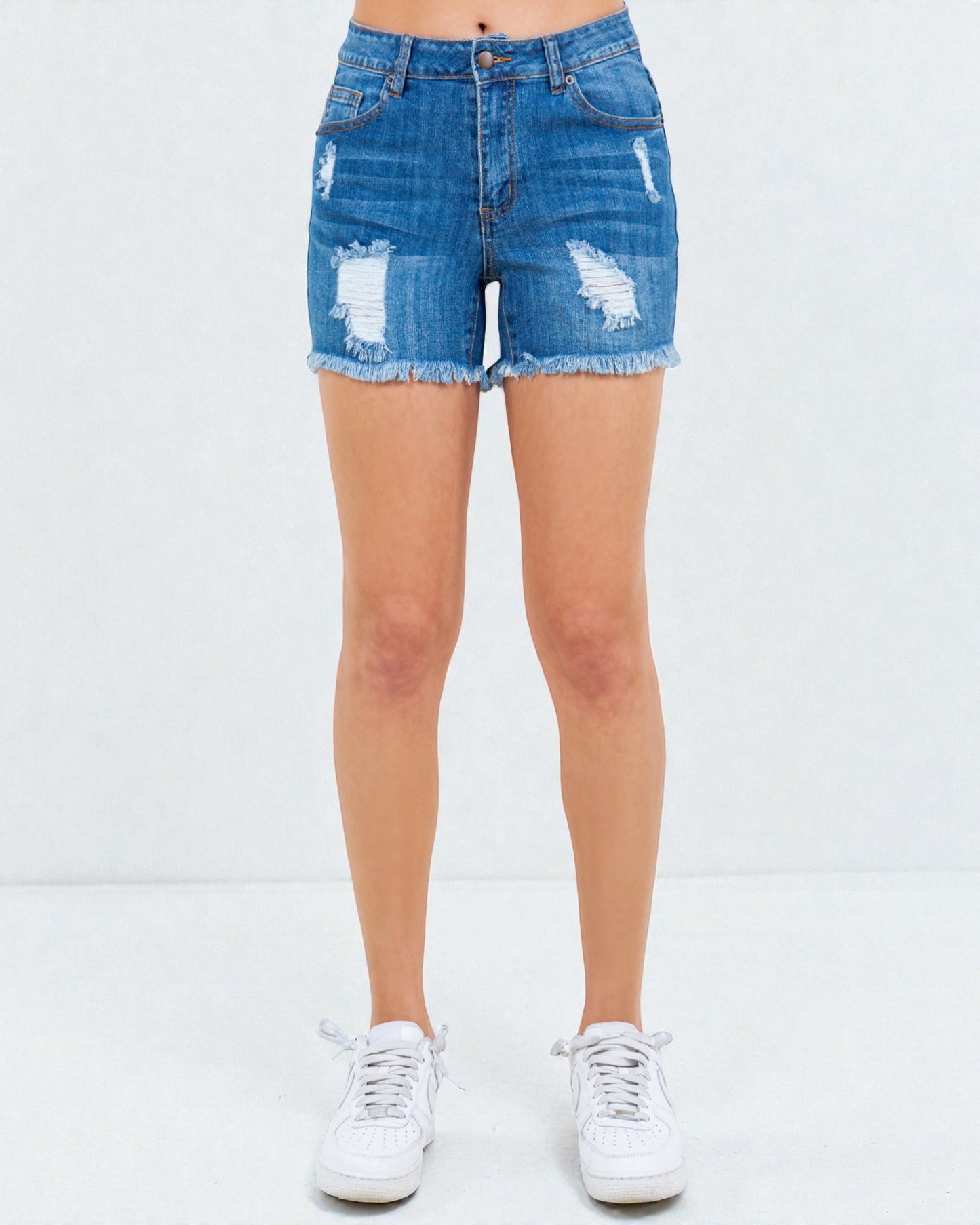Denim shorts with slight distressing on a white background