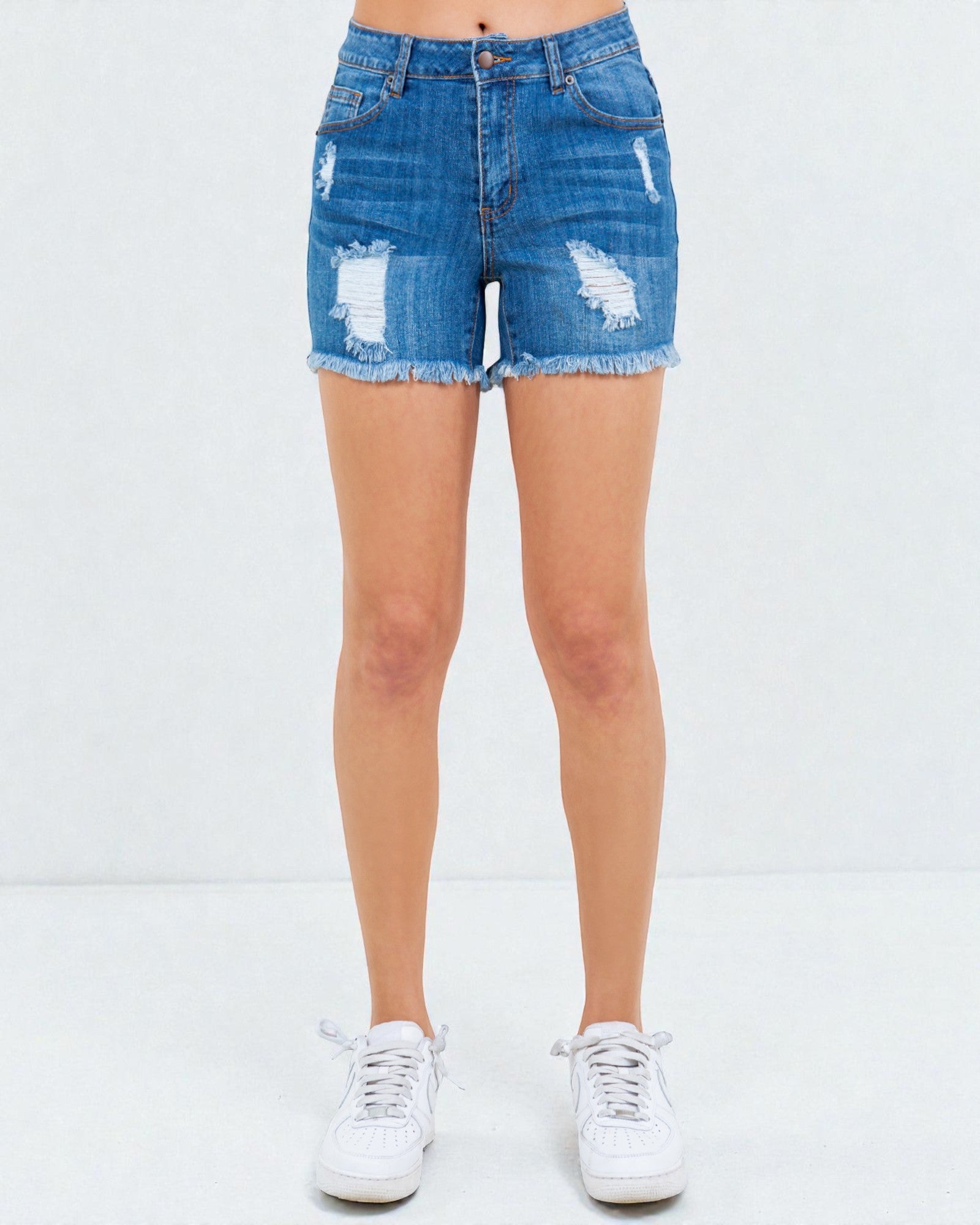 Denim shorts with slight distressing on a white background