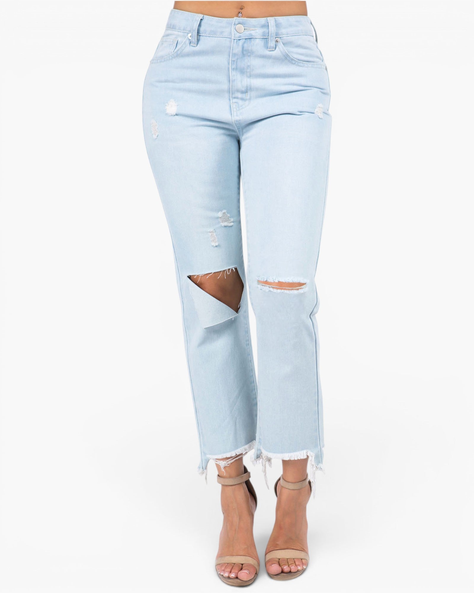 Light wash blue distressed jeans with ripped knee details and frayed hems, shown on a model wearing beige strappy high-heeled sandals against a plain white background.