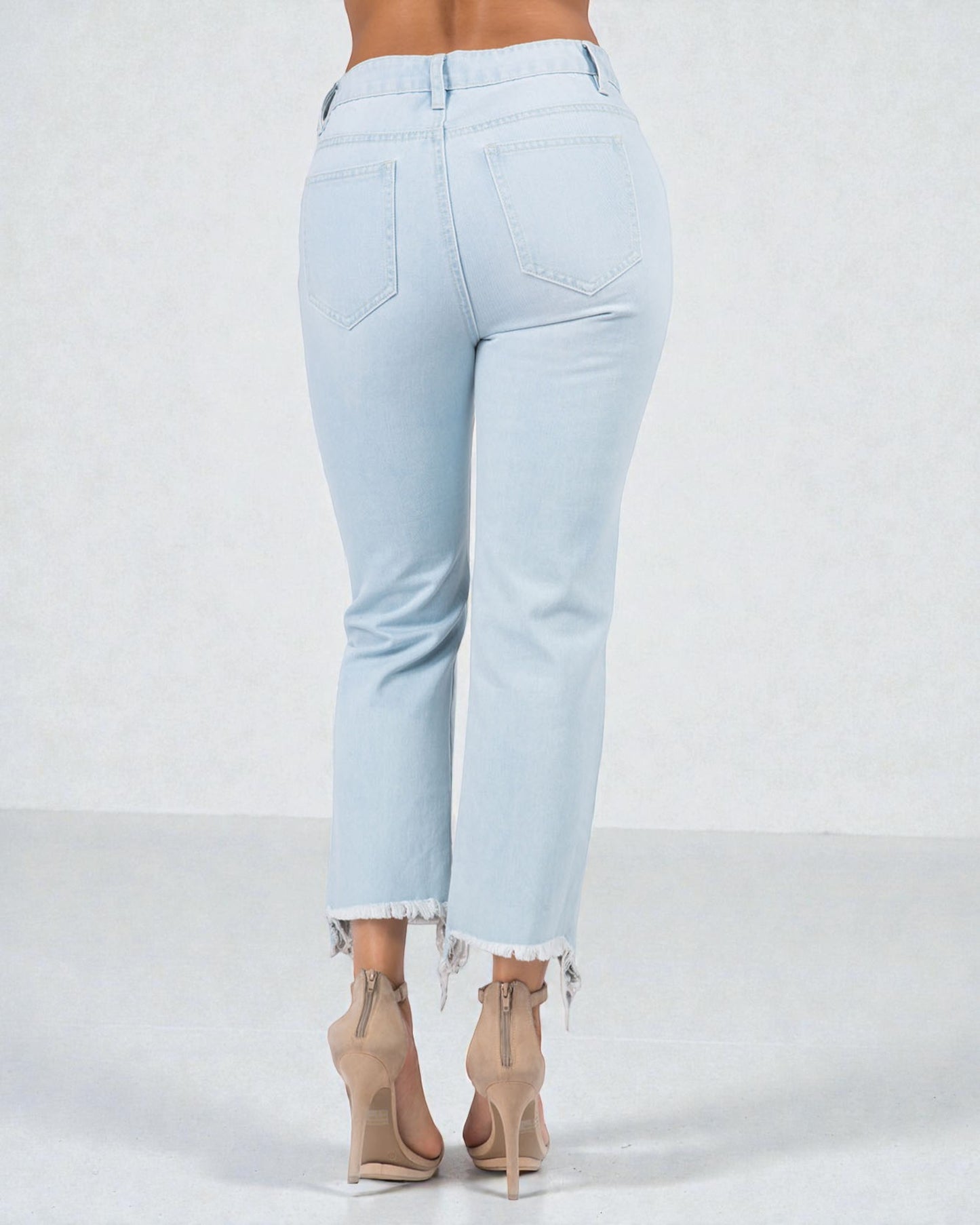 Light blue jeans worn by a person on a white background