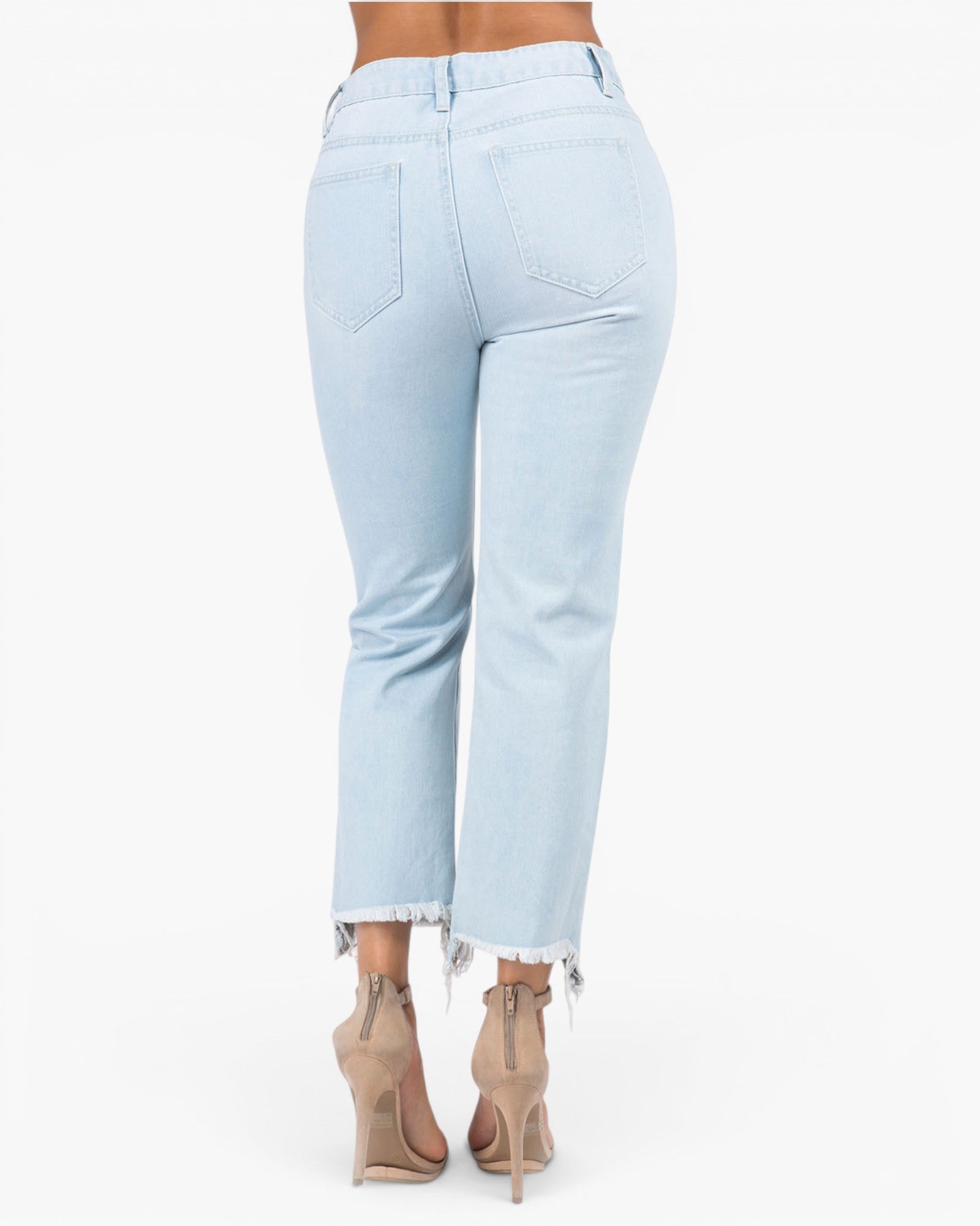 Light wash blue cropped jeans with a frayed hem, shown from the back on a model wearing beige high-heeled sandals against a white background.