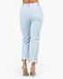 Light wash blue cropped jeans with a frayed hem, shown from the back on a model wearing beige high-heeled sandals against a white background.