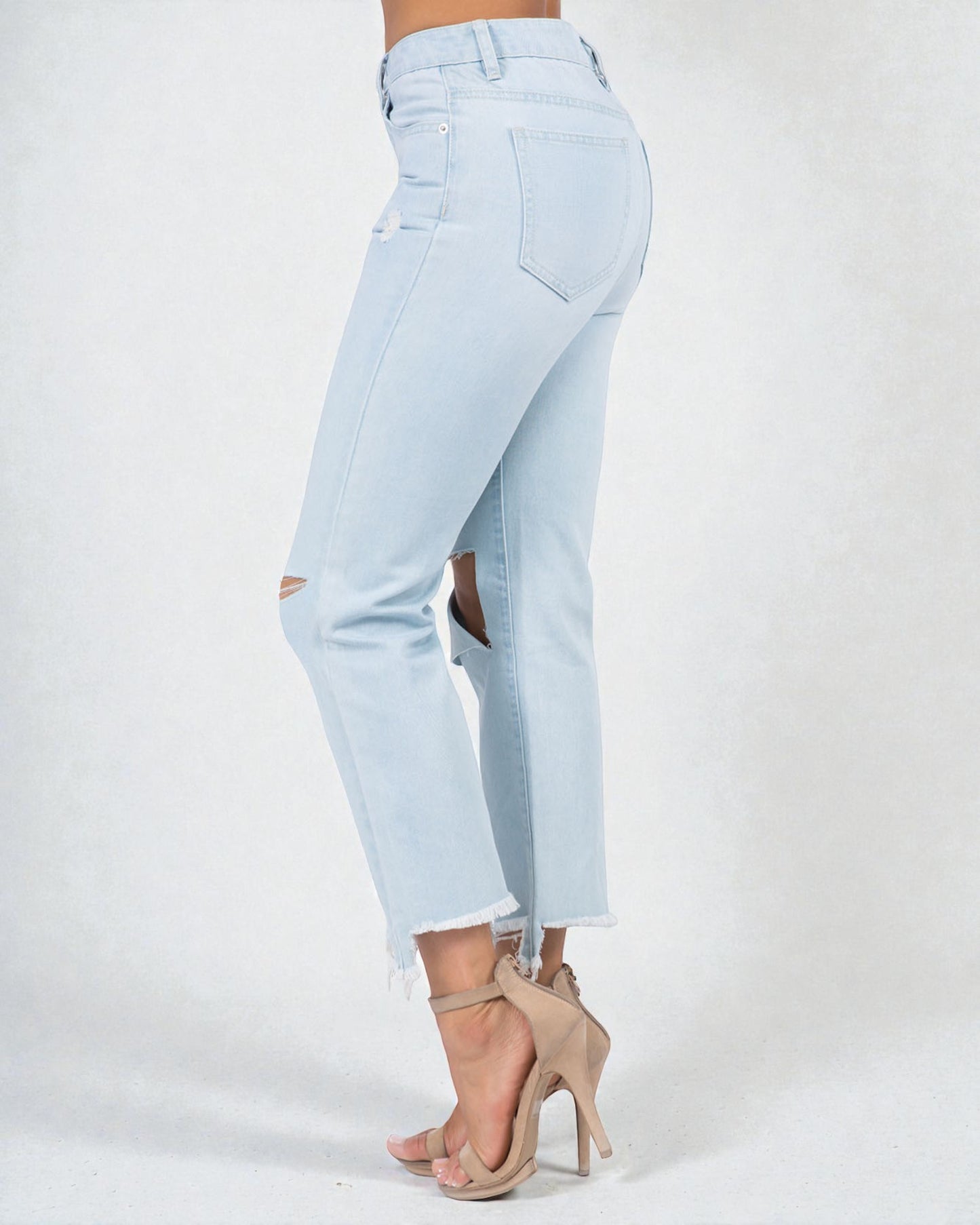 Light blue jeans with a cutout design on a white background